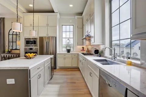a kitchen with stainless steel appliances a sink stove and refrigerator