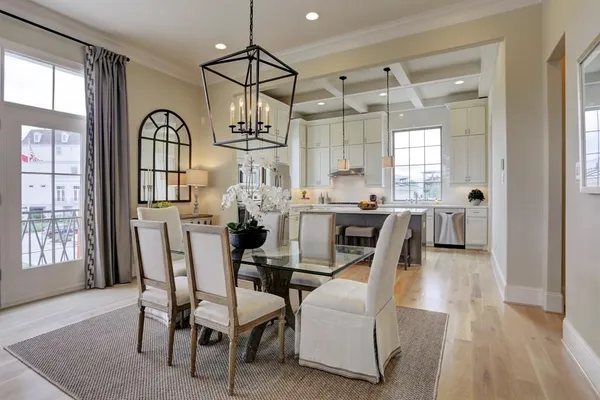 a dining room with furniture a chandelier and wooden floor