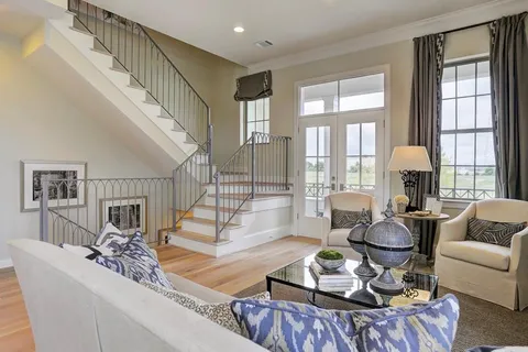 a living room with furniture fireplace and a large window