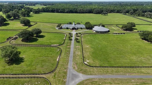an aerial view of a house with garden space and lake view
