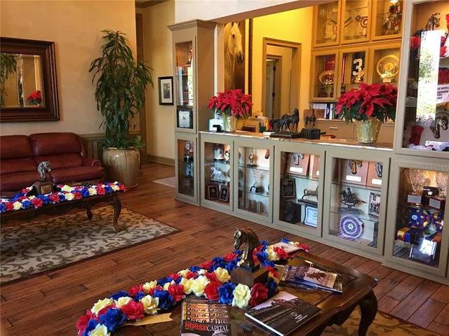 a living room with furniture a flat screen tv and a dining table