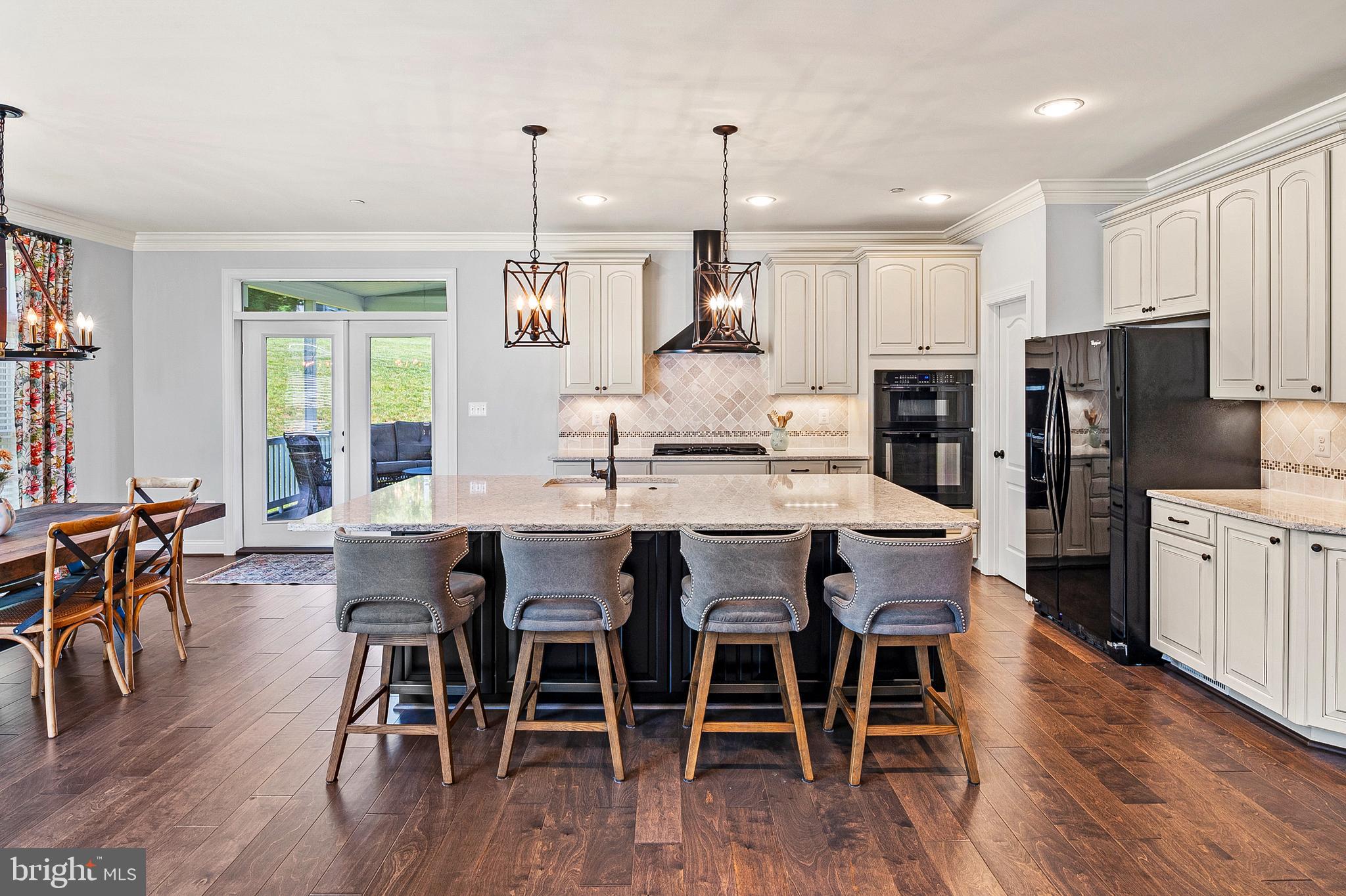 1760 Florence Road Mount Airy, MD 21771 - Photo 13 of 63 a dining room with stainless steel appliances kitchen island granite countertop a dining table chairs and refrigerator