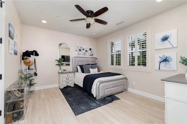 a bedroom with a bed and a television