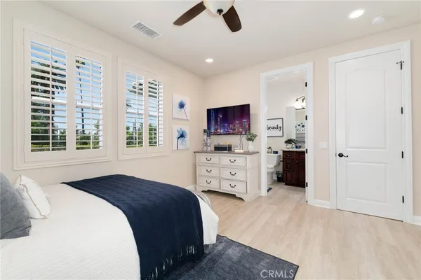 a dining room with furniture a flat screen tv and a large window