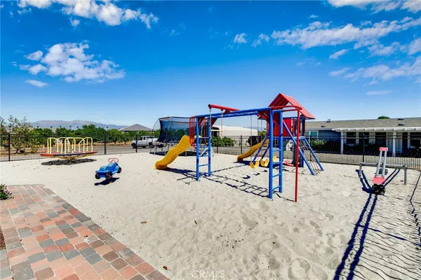 a bathroom with a granite countertop toilet sink and mirror