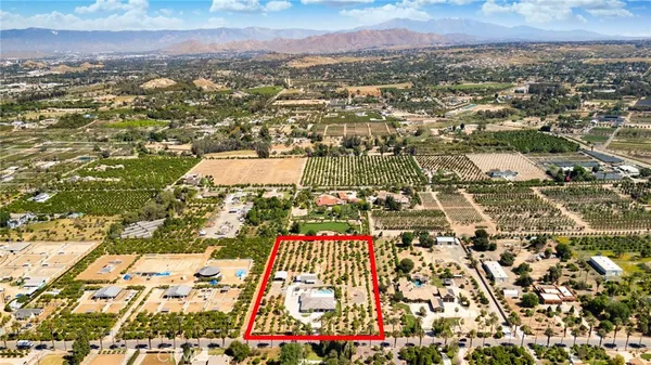 a large bedroom with a bed and a chandelier
