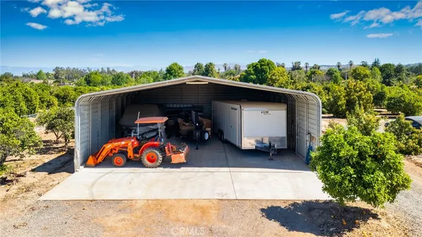 a large bedroom with a bed and a chandelier