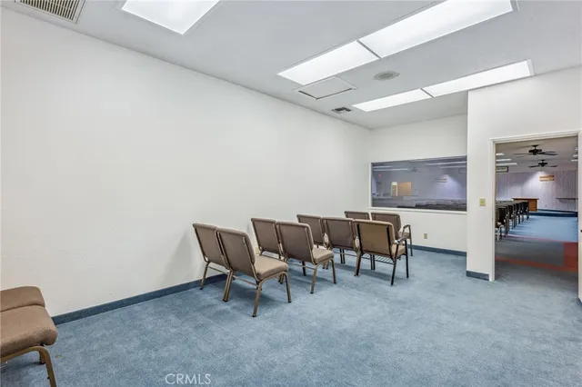 a view of a hallway with closet and wooden floor