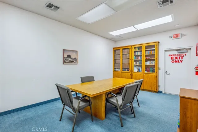 a view of a dining room with furniture and window
