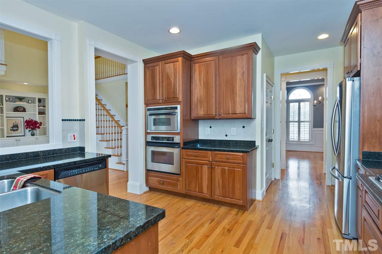 2001 Angelwing Court Raleigh, NC 27613 - Photo 3 of 23 a kitchen with stainless steel appliances granite countertop a refrigerator a stove and a wooden floors