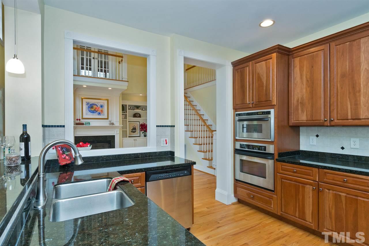 2001 Angelwing Court Raleigh, NC 27613 - Photo 4 of 23 a kitchen with stainless steel appliances granite countertop a sink dishwasher stove and refrigerator with wooden floor