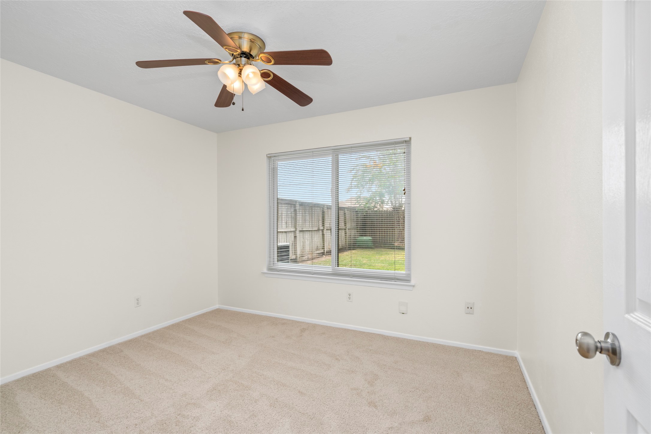 4715 Roserock Lane Spring, TX 77388 - Photo 10 of 17 Bright secondary bedroom! Includes brand new carpet, large Andersen windows, and bright neutral paint.