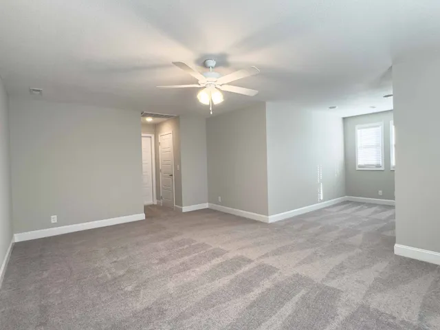 a view of an empty room with a fan
