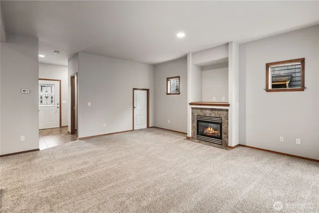 an empty room with furniture and a fireplace