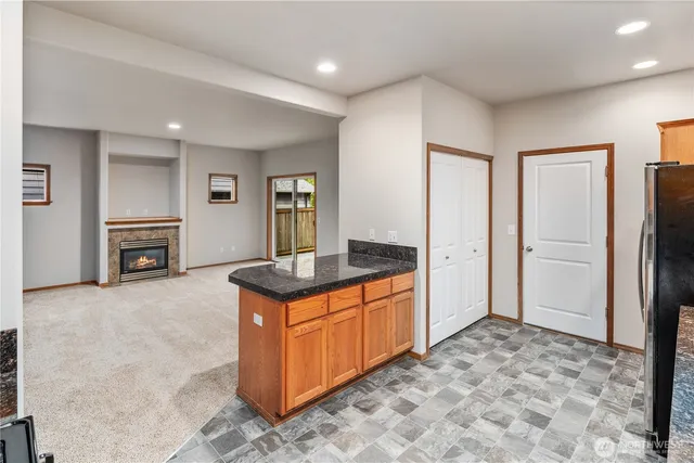 a kitchen with stainless steel appliances granite countertop a refrigerator and a stove top oven