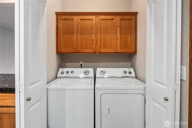 a view of storage and utility room with washer and dryer