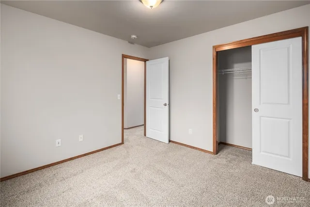 a view of an empty room and closet area