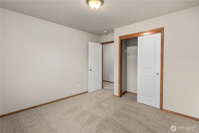 an empty room with closet area