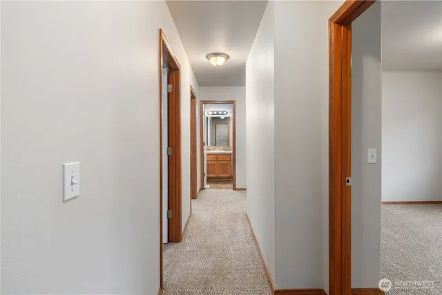 a view of a hallway with wooden floor