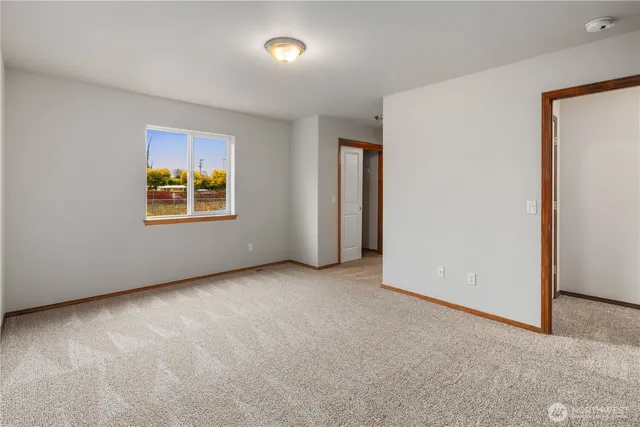 an empty room with a window and a projector