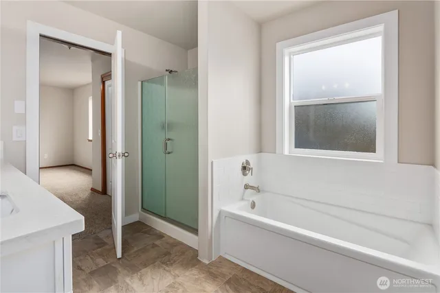 a bathroom with a bathtub and a shower