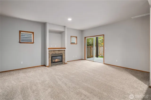 a view of a livingroom with a fireplace and window