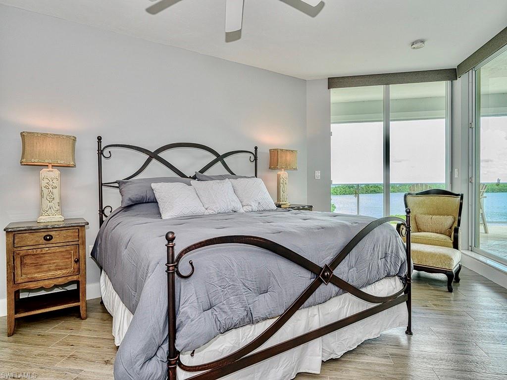 60 Seagate Drive, Unit 406 Naples, FL 34103 - Photo 11 of 26 a bedroom with a bed and window