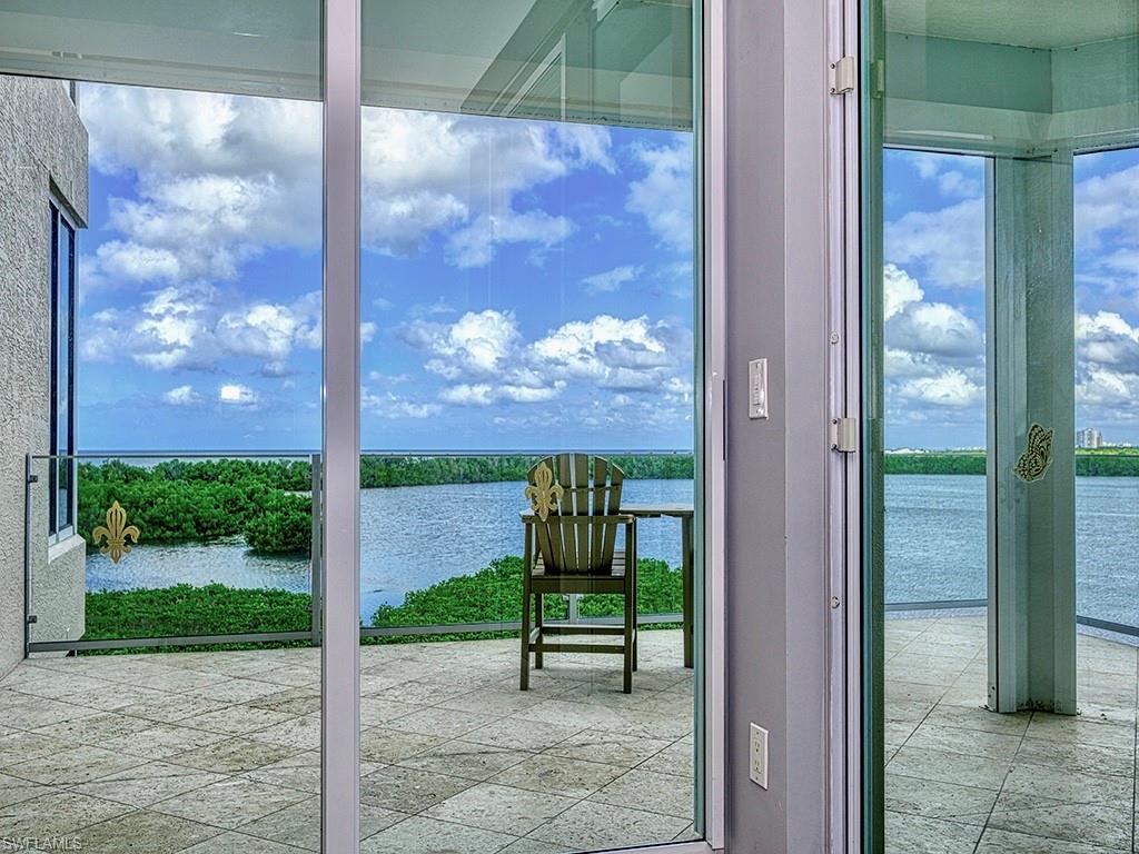 60 Seagate Drive, Unit 406 Naples, FL 34103 - Photo 12 of 26 a view of a bench in the porch