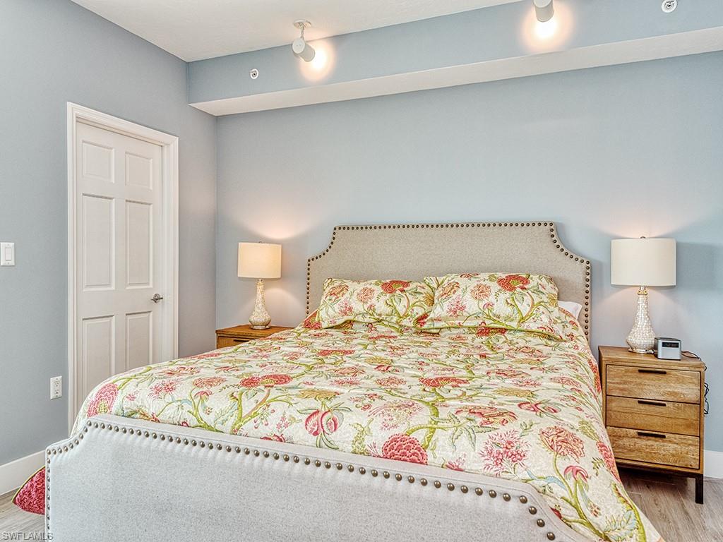 60 Seagate Drive, Unit 406 Naples, FL 34103 - Photo 15 of 26 a bedroom with a bed and a window