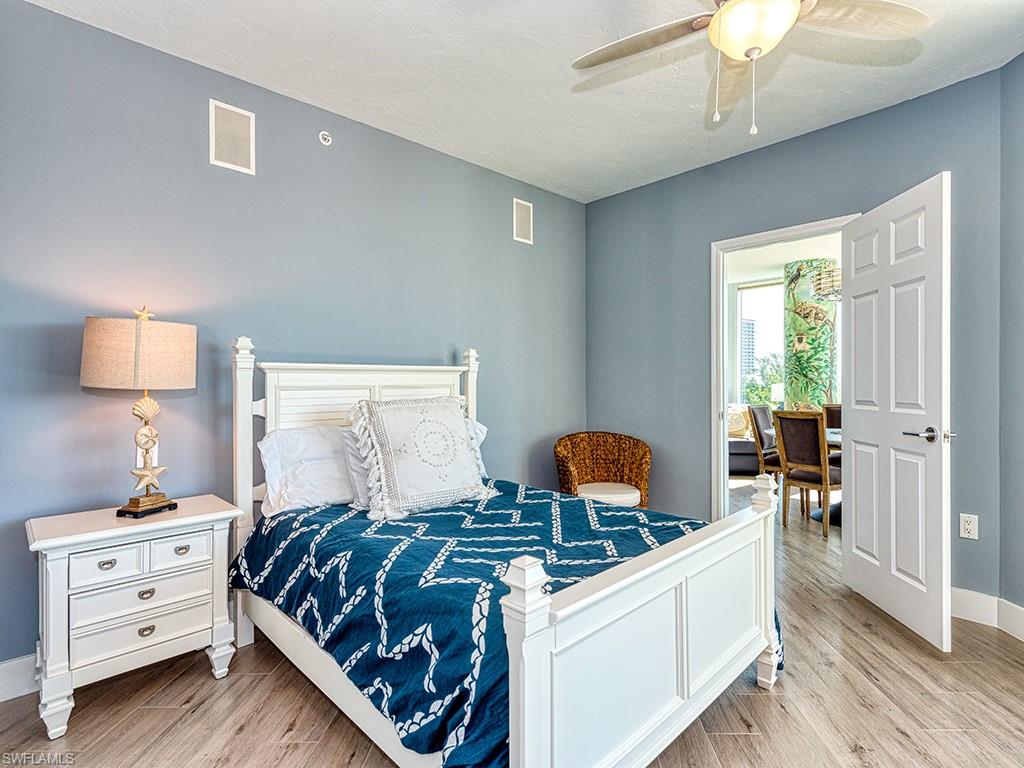 60 Seagate Drive, Unit 406 Naples, FL 34103 - Photo 17 of 26 a bedroom with furniture and a window