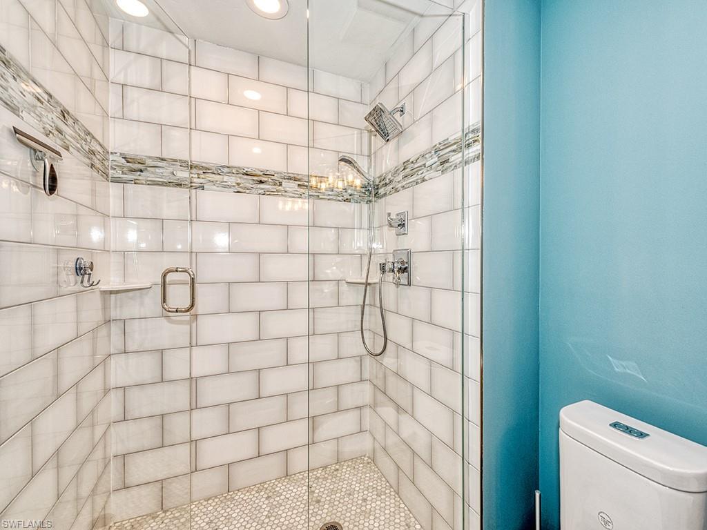 60 Seagate Drive, Unit 406 Naples, FL 34103 - Photo 18 of 26 a bathroom with a shower