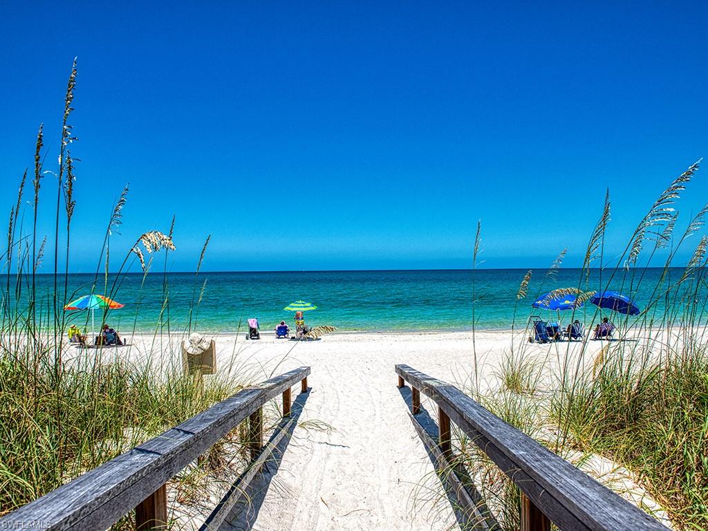60 Seagate Drive, Unit 406 Naples, FL 34103 - Photo 19 of 26 a view of a lake from a balcony