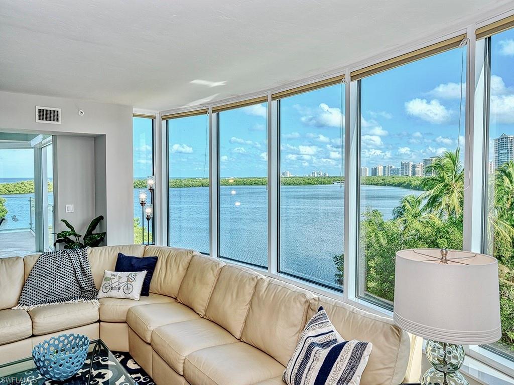 60 Seagate Drive, Unit 406 Naples, FL 34103 - Photo 2 of 26 a living room with furniture and a window