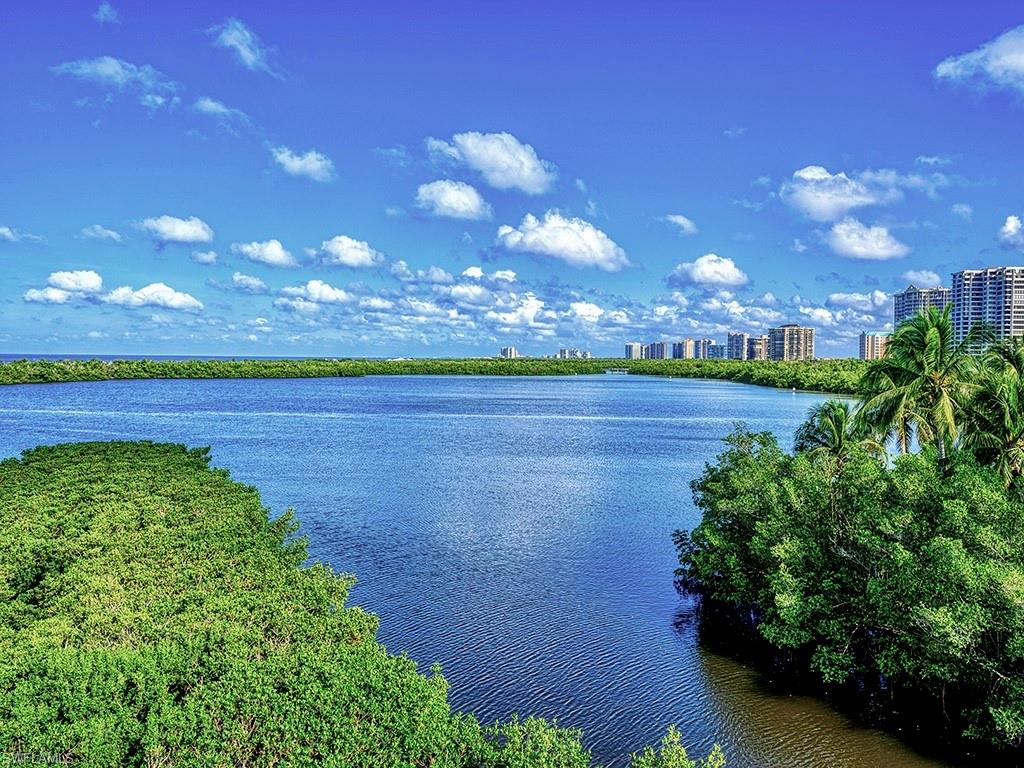 60 Seagate Drive, Unit 406 Naples, FL 34103 - Photo 21 of 26 a view of a lake with outdoor space