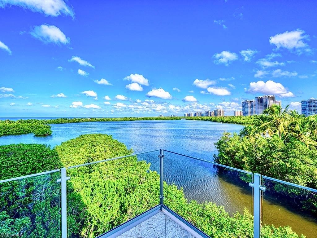 60 Seagate Drive, Unit 406 Naples, FL 34103 - Photo 22 of 26 a view of a lake with a yard