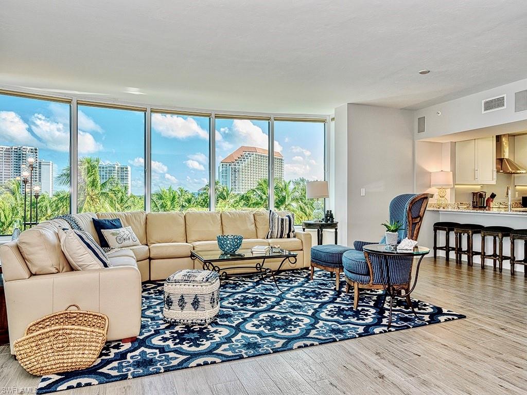 60 Seagate Drive, Unit 406 Naples, FL 34103 - Photo 3 of 26 a living room with furniture and a window