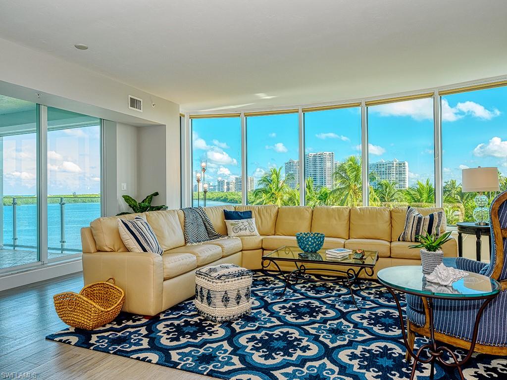 60 Seagate Drive, Unit 406 Naples, FL 34103 - Photo 4 of 26 a living room with furniture and a large window