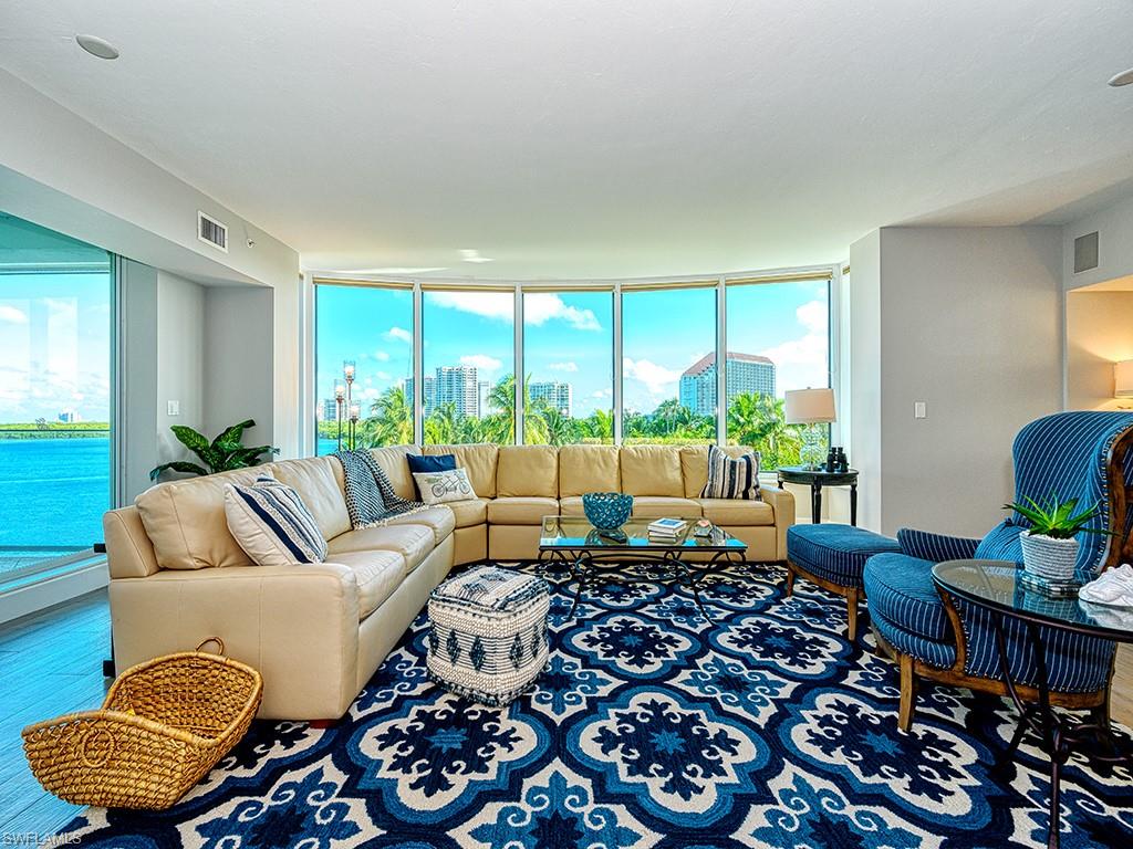 60 Seagate Drive, Unit 406 Naples, FL 34103 - Photo 5 of 26 a living room with furniture and a large window