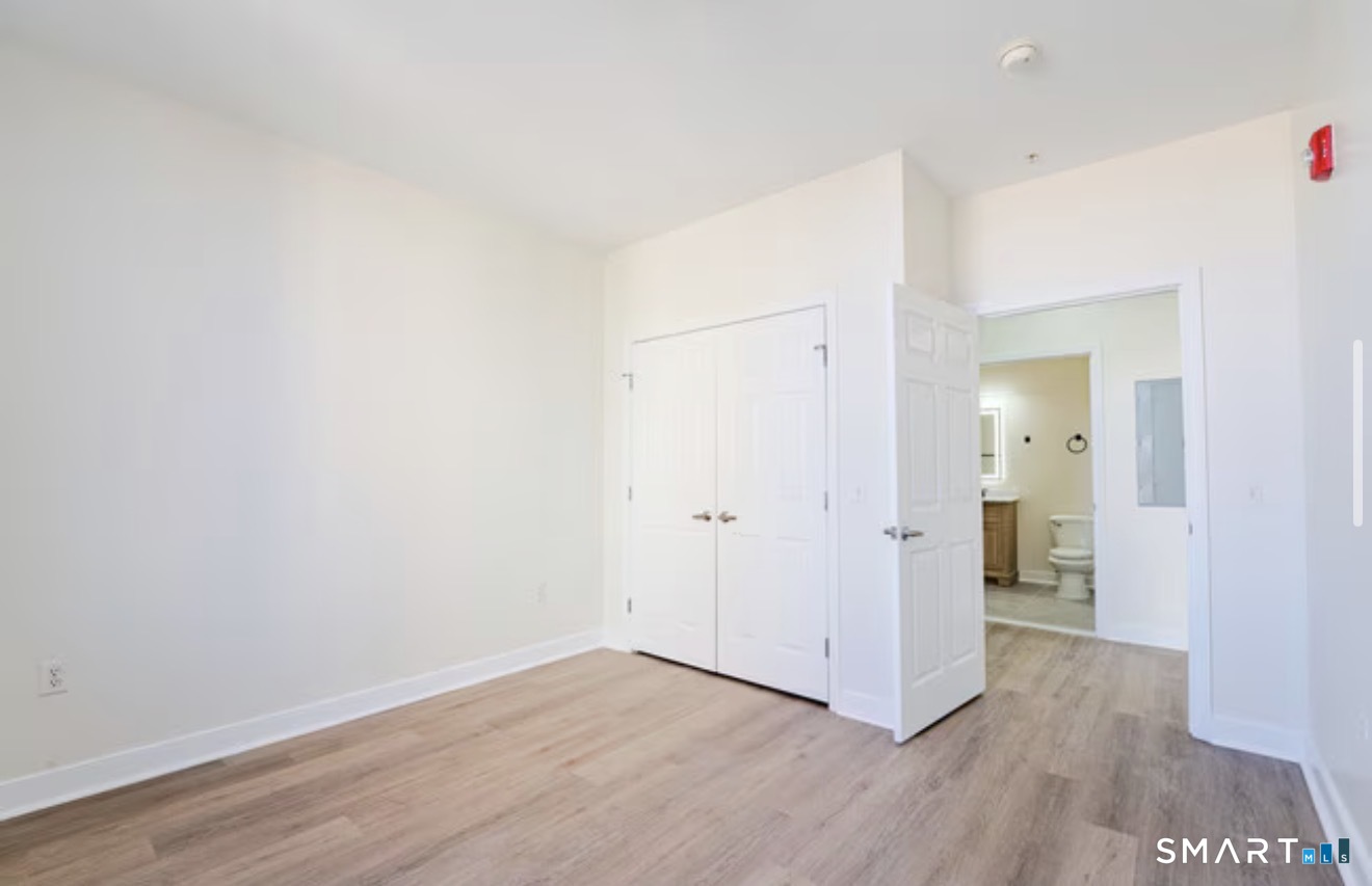 333 State Street, Unit 410 Bridgeport, CT 06604 - Photo 4 of 6 a view of a room with wooden floor