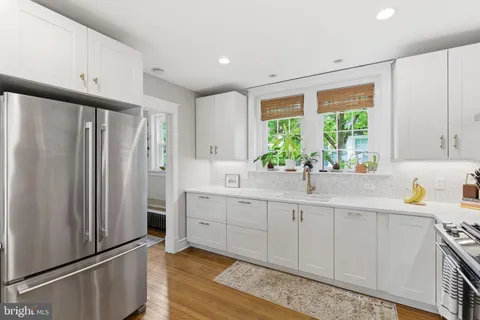 a kitchen with stainless steel appliances a refrigerator sink and cabinets