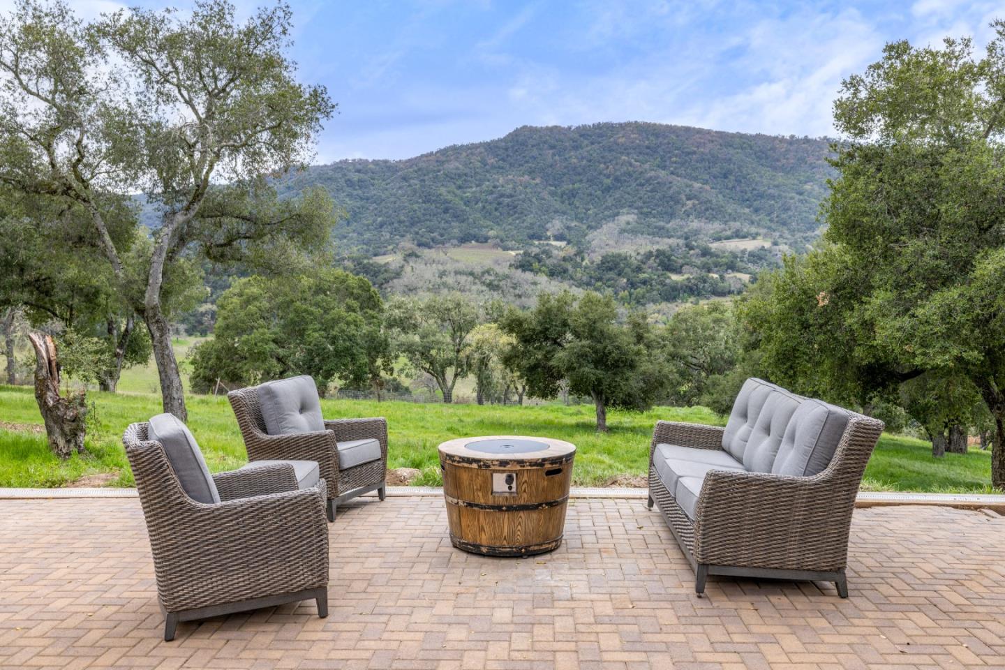 19235 Cachagua Road Carmel Valley, CA 93924 - Photo 14 of 34 a view of a patio with couches chairs and a yard