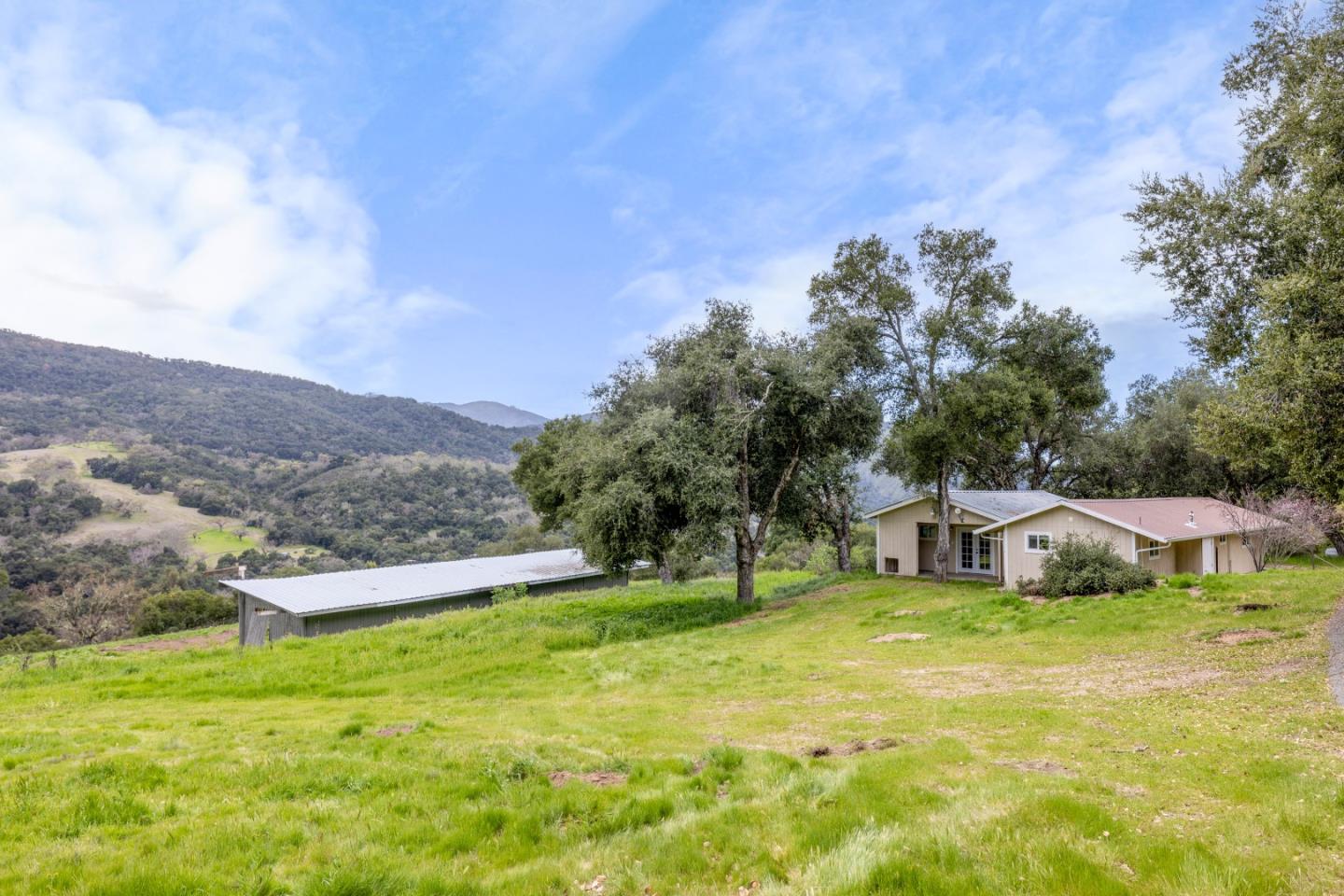 19235 Cachagua Road Carmel Valley, CA 93924 - Photo 17 of 34 a view of a house with a yard