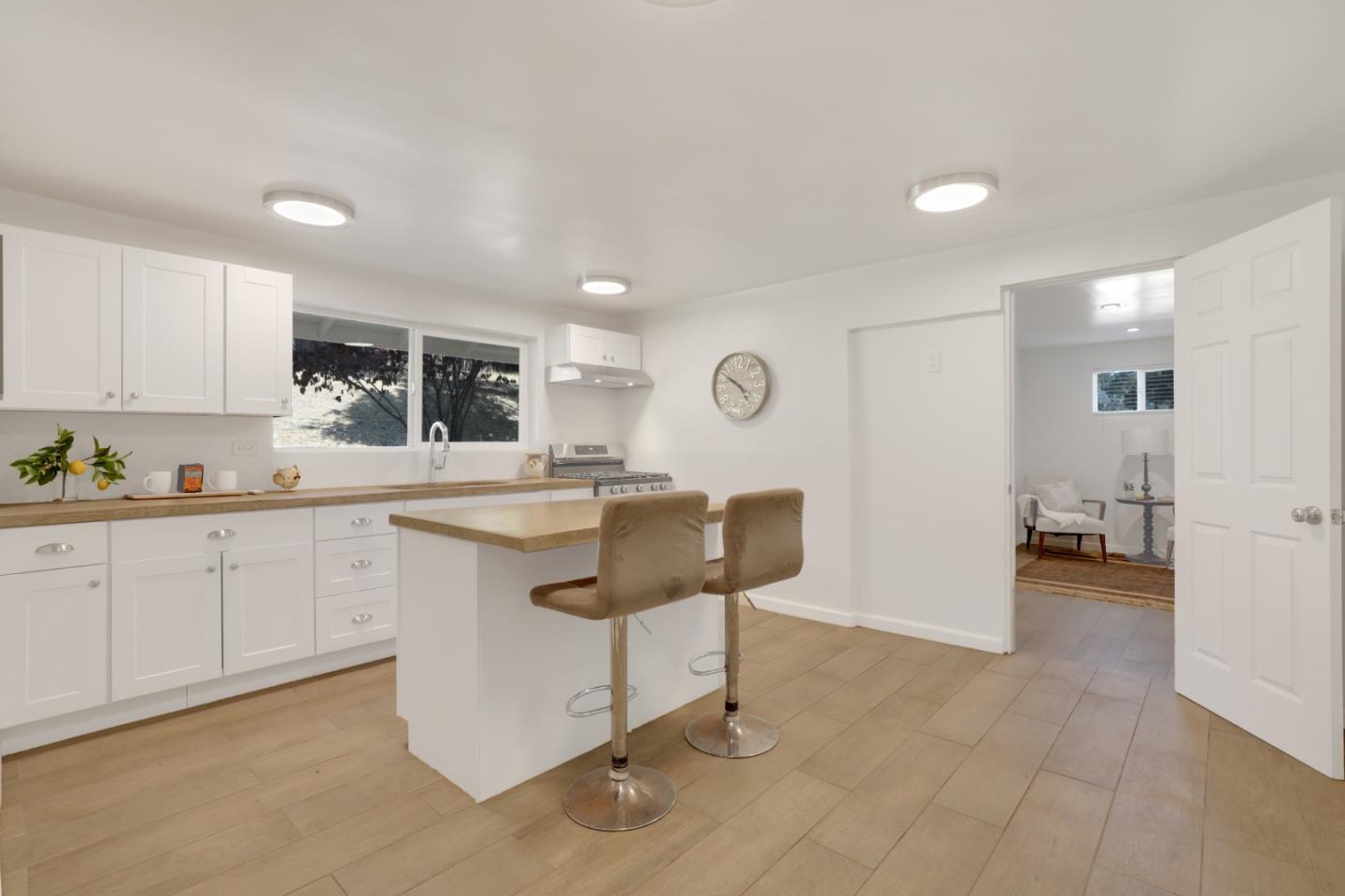 19235 Cachagua Road Carmel Valley, CA 93924 - Photo 23 of 34 a kitchen with cabinets and chairs