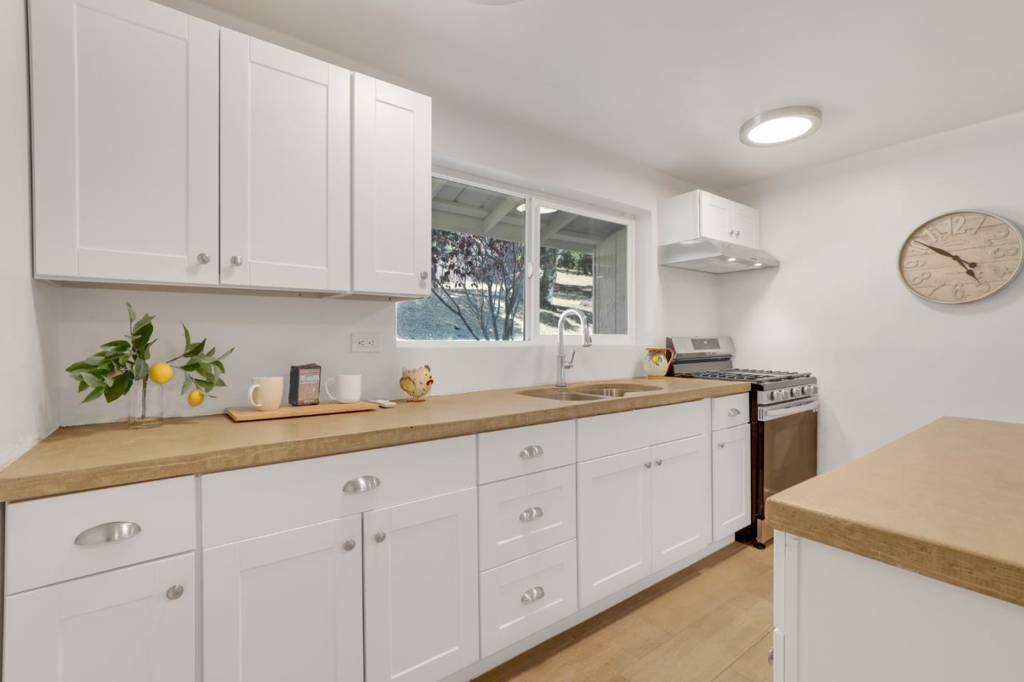 19235 Cachagua Road Carmel Valley, CA 93924 - Photo 24 of 34 a kitchen with white cabinets and white appliances