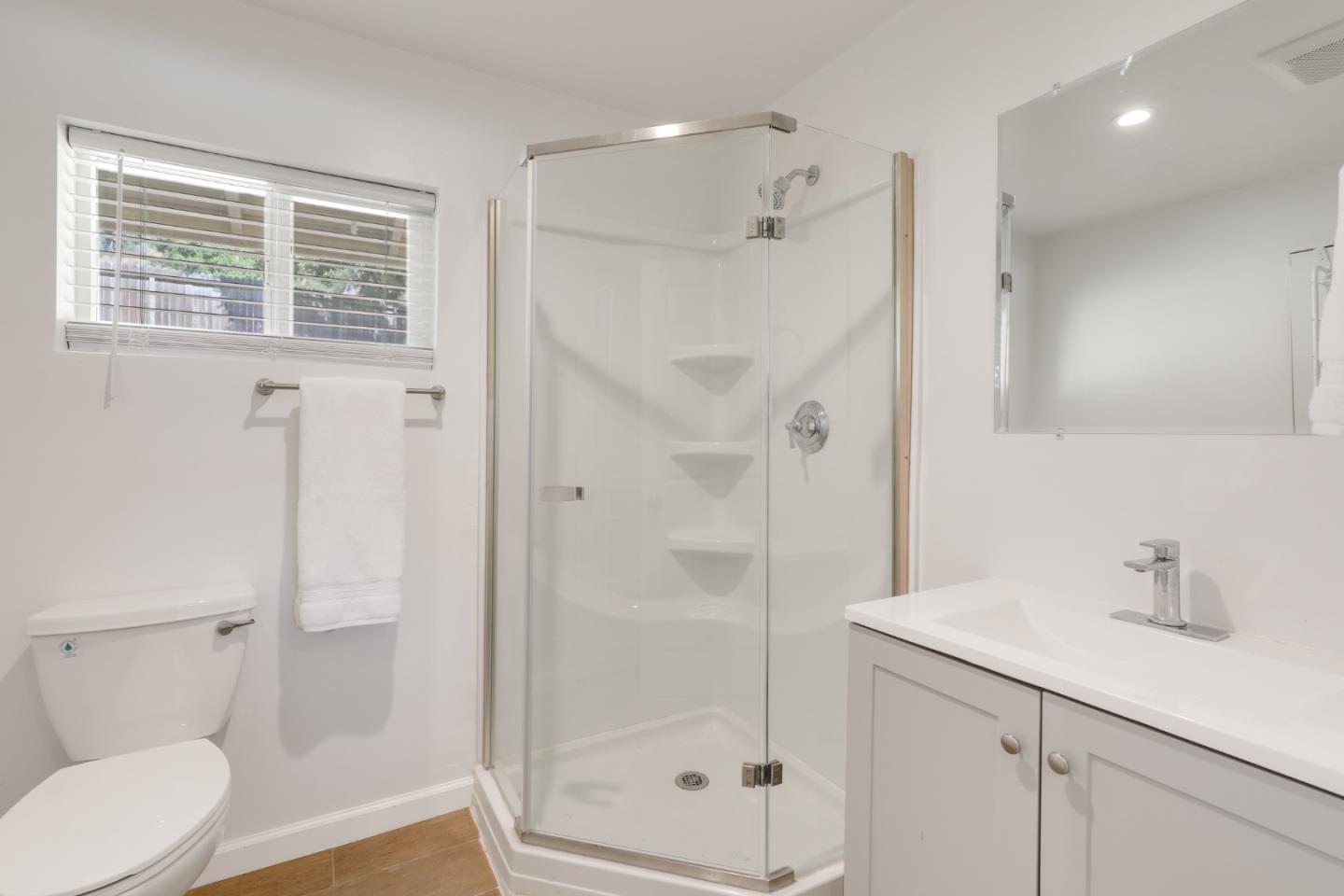 19235 Cachagua Road Carmel Valley, CA 93924 - Photo 26 of 34 a bathroom with a shower sink vanity and toilet