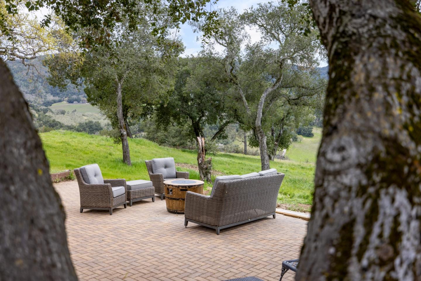 19235 Cachagua Road Carmel Valley, CA 93924 - Photo 30 of 34 a view of a patio with couches chairs and a yard