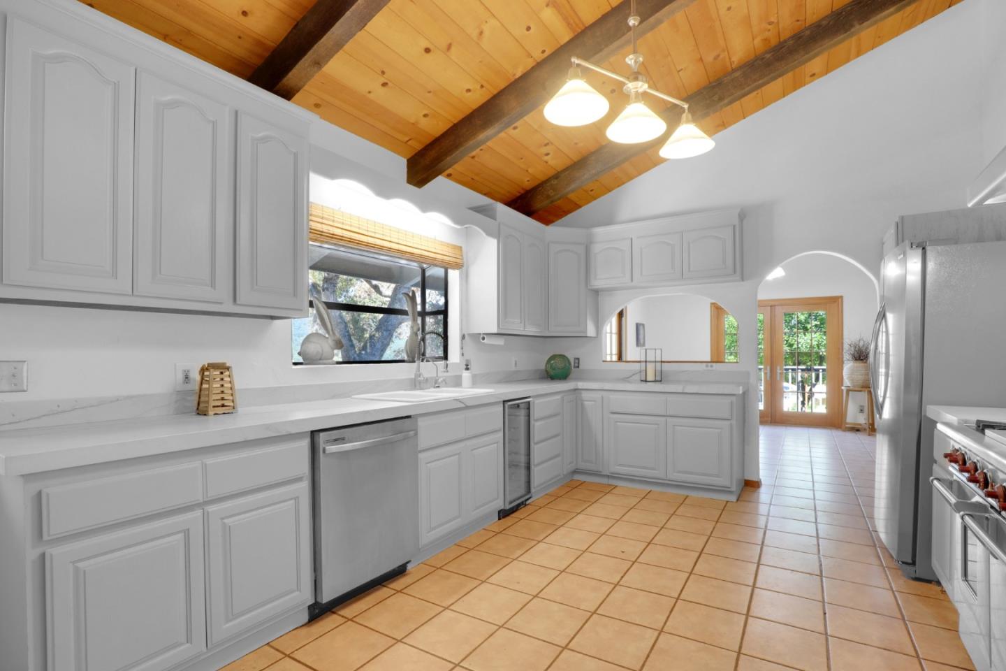 19235 Cachagua Road Carmel Valley, CA 93924 - Photo 7 of 34 a kitchen with a sink window and cabinets
