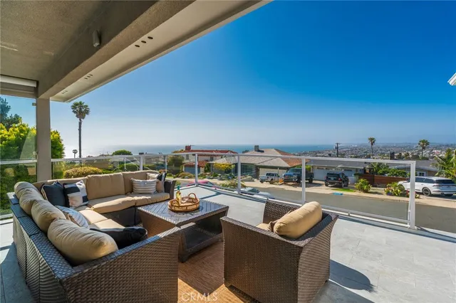 a front view of a house with a yard and outdoor seating