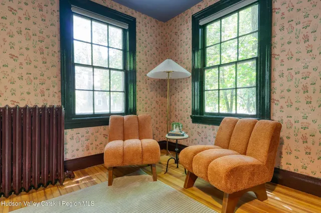 a dining room with fireplace furniture and a large window