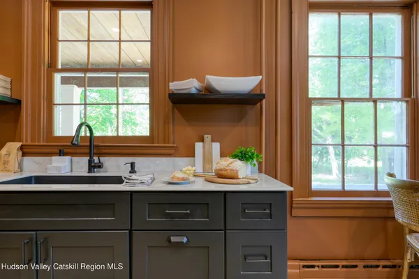 a kitchen with kitchen island granite countertop a sink stove and refrigerator